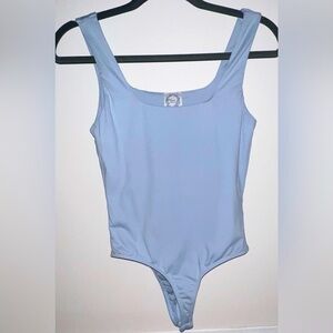 Light blue body suit.